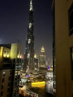 a view of a city at night with tall buildings at INA Homes-Tower 5 Perfect Burj Khalifa and Fountain Views in Dubai