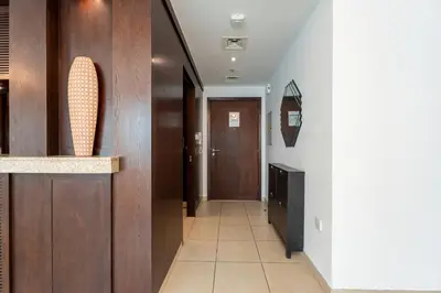 a hallway with wood paneled walls and a door at INA Homes-Tower 5 Perfect Burj Khalifa and Fountain Views in Dubai