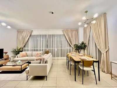 a living room with a couch and a table at INA Homes-Tower 5 Perfect Burj Khalifa and Fountain Views in Dubai