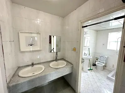 a bathroom with two sinks and a toilet at Nice Rooms for Rent in Compound Housing near Burj Alarab Dubai Villa 125 in Dubai