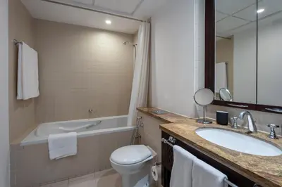 a bathroom with a sink and a toilet and a tub at INA Homes-BLVD Central 2BHK Apartment near Burj Khalifa in Dubai