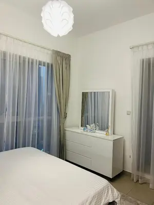 a bedroom with a white bed and a mirror at INA Homes-BLVD Central 2BHK Apartment near Burj Khalifa in Dubai