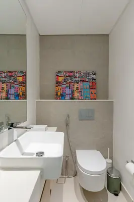 a bathroom with a white toilet and a sink at Sleek 1 Bedroom with Views of Dubai Marina in Dubai
