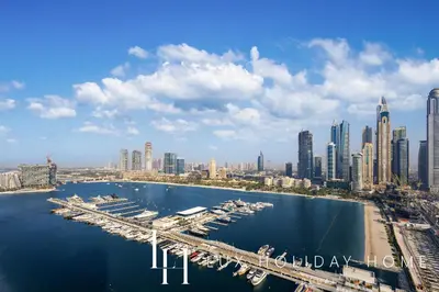 an aerial view of a city with a marina at LUX The Ultimate Palm Sea Skyline Penthouse in Dubai
