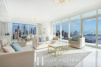 a living room with white furniture and large windows at LUX The Ultimate Palm Sea Skyline Penthouse in Dubai