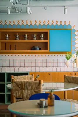 a room with a tv and a table and chairs at Shada Hotel Dubai - فندق شدا دبي in Dubai