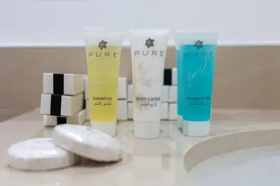 a group of four products sitting on a bathroom counter at Nice 1Bedroom - UNA Townsquare in Dubai