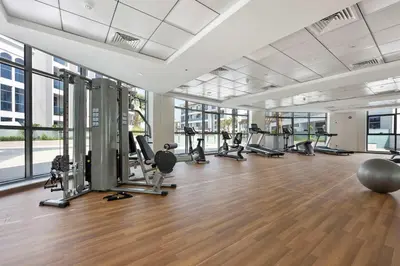 a gym with treadmills and exercise equipment in a building at Silkhaus exquisite studio in Art Gardens with gym access in Dubai