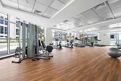 a gym with treadmills and exercise equipment in a building at Silkhaus Chic Studio in Art Gardens Modern Living in Dubai
