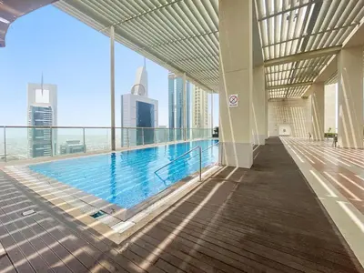 a swimming pool in a building with a view of the city at Silkhaus modern studio in Liberty House in Dubai