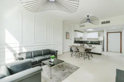 a living room with a couch and a table at RH- Urban Living, spacious 01BR, near burj Khalifa in Dubai