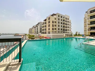 a large swimming pool on top of a building at HiGuests - Stylish Waterfront Retreat With Balcony in La Mer in Dubai