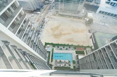 an aerial view of a pool in the middle of a building at White Sage - DAMAC Zada Tower in Dubai