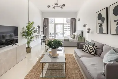 a living room with a couch and a table at Frank Porter - Oasis Tower 1 in Dubai