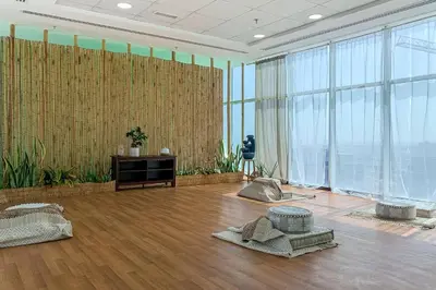a large room with a wooden floor and large windows at Frank Porter - Oasis Tower 1 in Dubai