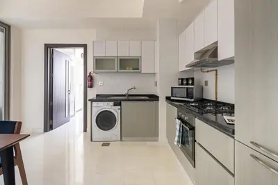 a kitchen with a washer and dryer in it at Frank Porter - Bayz Tower by Danube in Dubai