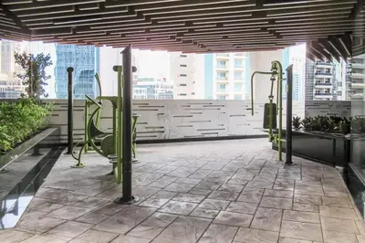 a gym with green poles in a building at Frank Porter - Bayz Tower by Danube in Dubai