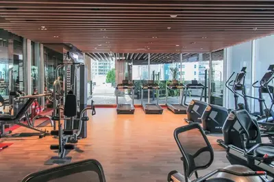 a gym with treadmills and cardio equipment in a building at Frank Porter - Bayz Tower by Danube in Dubai