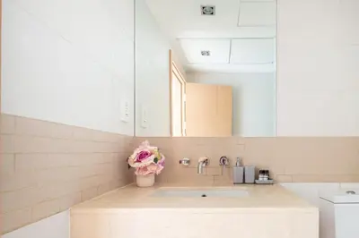 a kitchen with a sink and a vase of flowers at Frank Porter - Blakely Tower in Dubai