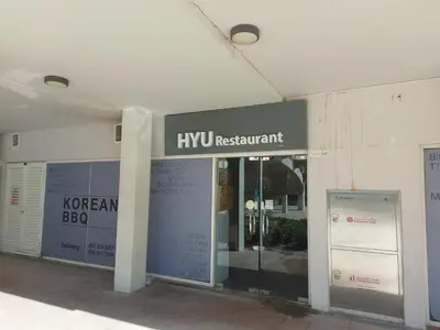 a building with a kyru restaurant sign on it at White Sage - Gorgeous Apartment in JLT Near the Metro Station in Dubai