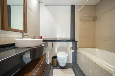 a bathroom with a sink and a toilet and a tub at Everluxe Lovely Studio Apt In Business Bay in Dubai
