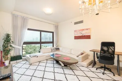 a living room with a couch and a table at Daniels Sea View 2BR in Fairmont The Palm in Dubai