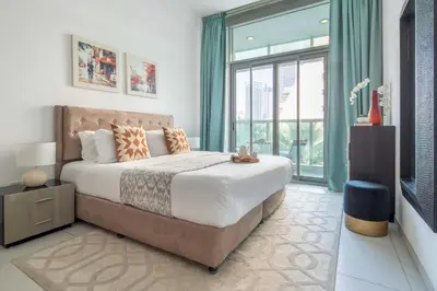 a bedroom with a large bed and a large window at Frank Porter - Panoramic Tower in Dubai