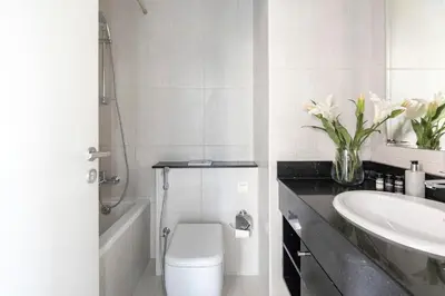 a bathroom with a toilet and a sink and a tub at Frank Porter - Tower 108 in Dubai