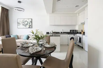 a kitchen and living room with a table and chairs at Frank Porter - Tower 108 in Dubai
