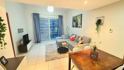 a living room with a couch and a table at Alluring 1BR Opp to JBR Beach- Marina Views in Dubai