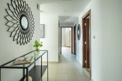 a hallway with a glass table and a mirror at Frank Porter - South Ridge 6 in Dubai