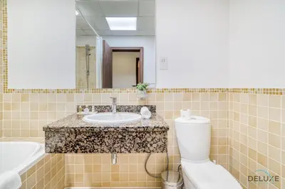 a bathroom with a sink and a toilet at Exquisite 2BR At Shams 1 JBR by Deluxe Holiday Homes in Dubai