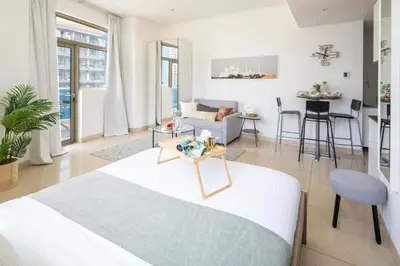 a room with a bed and a living room at Frank Porter - Yach Bay in Dubai