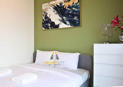 a bedroom with a bed with a sign on it at Fully Furnished 1 Bed in Sobha Creek Vista hosted by Desert City Stays in Dubai