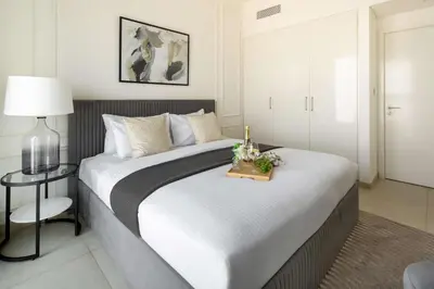 a bedroom with a large bed with a candle on it at Frank Porter - Downtown Views 2 in Dubai