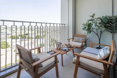 a living room with a table and chairs and a balcony at Frank Porter - Downtown Views 2 in Dubai