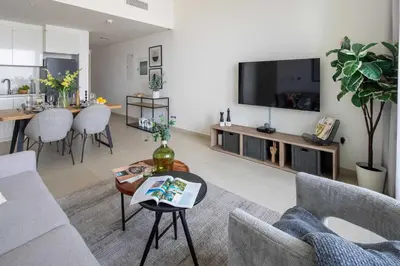 a living room with a couch and a tv at Frank Porter - Downtown Views 2 in Dubai