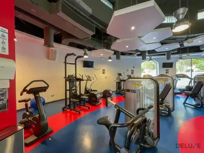 a gym with treadmills and elliptical machines at Stylish 2BR At Shams 1 JBR by Deluxe Holiday Homes in Dubai