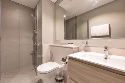 a bathroom with a toilet and a sink and a shower at ALiving Luxury 1BR with Canal View I Near Burj Khalifa & Dubai Mall I Zada Tower, 2613 in Dubai
