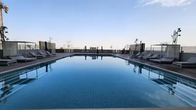 a large swimming pool with lounge chairs on a building at STAY BY LATINEM Luxury 1BR Holiday Home CVR A1513 near Burj Khalifa in Dubai