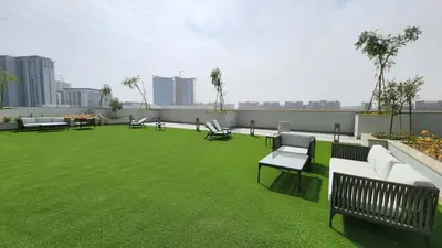 a rooftop patio with benches and grass on a building at STAY BY LATINEM Luxury 1BR Holiday Home CVR A1513 near Burj Khalifa in Dubai