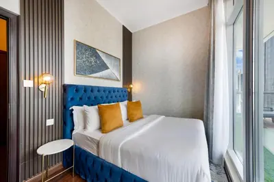 a bedroom with a large bed with a blue headboard at Durrani Homes - Alluring 5BR Penthouse with Burj Khalifa and Fountain View in Dubai