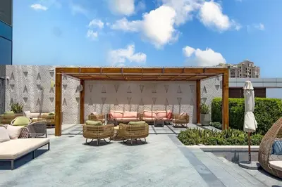 a patio with wicker chairs and a pavilion at FAM Living - Palm Tower Attached to St Regis Palm Tower 1Bed - Palm Jumeirah Views in Dubai
