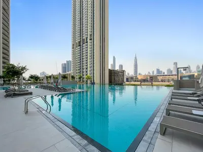 a large swimming pool in the middle of a city at Silkhaus lavish 1BDR in new tower with pool & gym access in Dubai