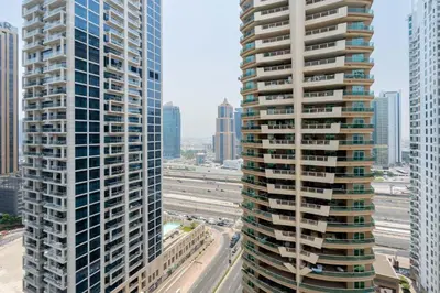 a view of two tall buildings in a city at GuestReady - Moment in time at Al Majara in Dubai