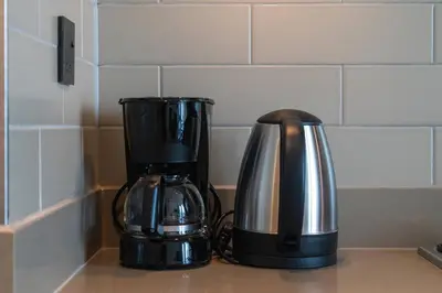a coffee maker and a coffee pot on a counter at 10min from Burj Khalifa - Sobha Creek Vistas Réservé in Dubai