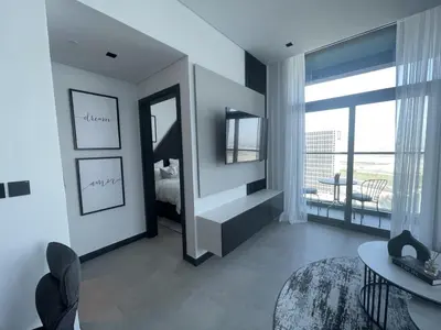 a living room with a bed and a mirror at Iconic !Luxurious 1 Bed Apartment! in Dubai