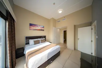 a bedroom with a large bed in a room at City Stay Residences - Serviced Apartments DIP in Dubai