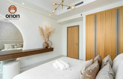 a bedroom with a bed and a wooden shelf at Paramount 2 Bed Apt, Roof Top Bar and Pool overlooking Burj, Triple Balcony, Fully Equipped, Free Toiletries, Full Kitchen, 2 and half Bathrooms, Ground Floor Supermarket, Influencers Haven, Sunrise and Sunset Views over the Sea From All Balcony in Dubai
