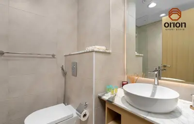a bathroom with a sink and a toilet at Paramount 2 Bed Apt, Roof Top Bar and Pool overlooking Burj, Triple Balcony, Fully Equipped, Free Toiletries, Full Kitchen, 2 and half Bathrooms, Ground Floor Supermarket, Influencers Haven, Sunrise and Sunset Views over the Sea From All Balcony in Dubai